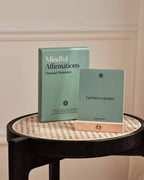 Financial abundance affirmation card and box arranged on a tabletop.