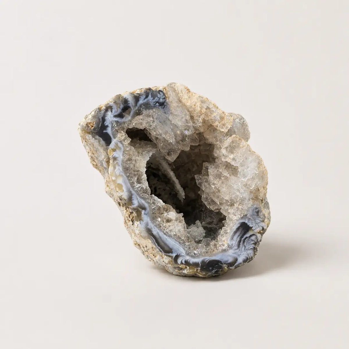 LumaStone Agate Crystal Cave Ornament, a raw stone decor with polished black and white swirling bands and clear cryst...