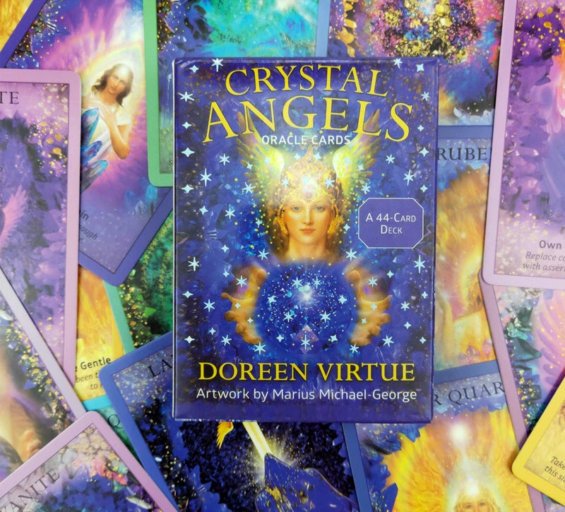 Moonveil Crystal Angels Oracle Cards deck box by Doreen Virtue, surrounded by scattered colorful oracle cards on a vibrant, mystical background.