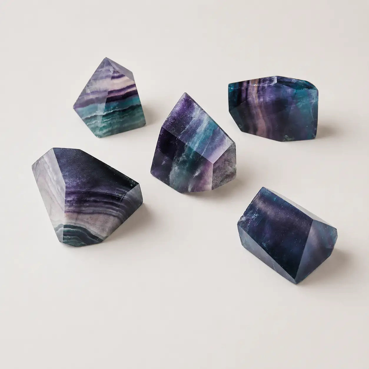 LumaStone rainbow fluorite polyhedron ornaments, a set of five colorful spiritual home decor crystals.