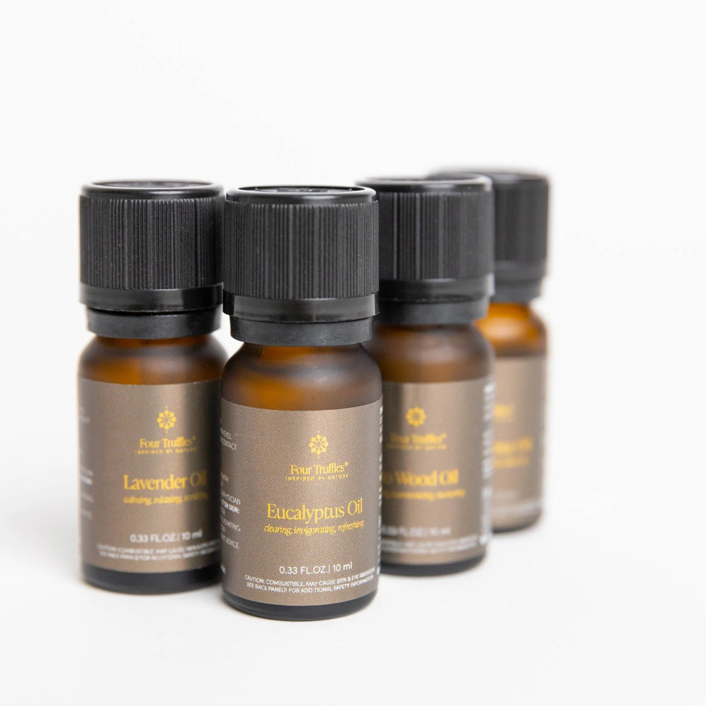 Four Truffles Wellness Molecules Essential Oil bottles arranged stylistically