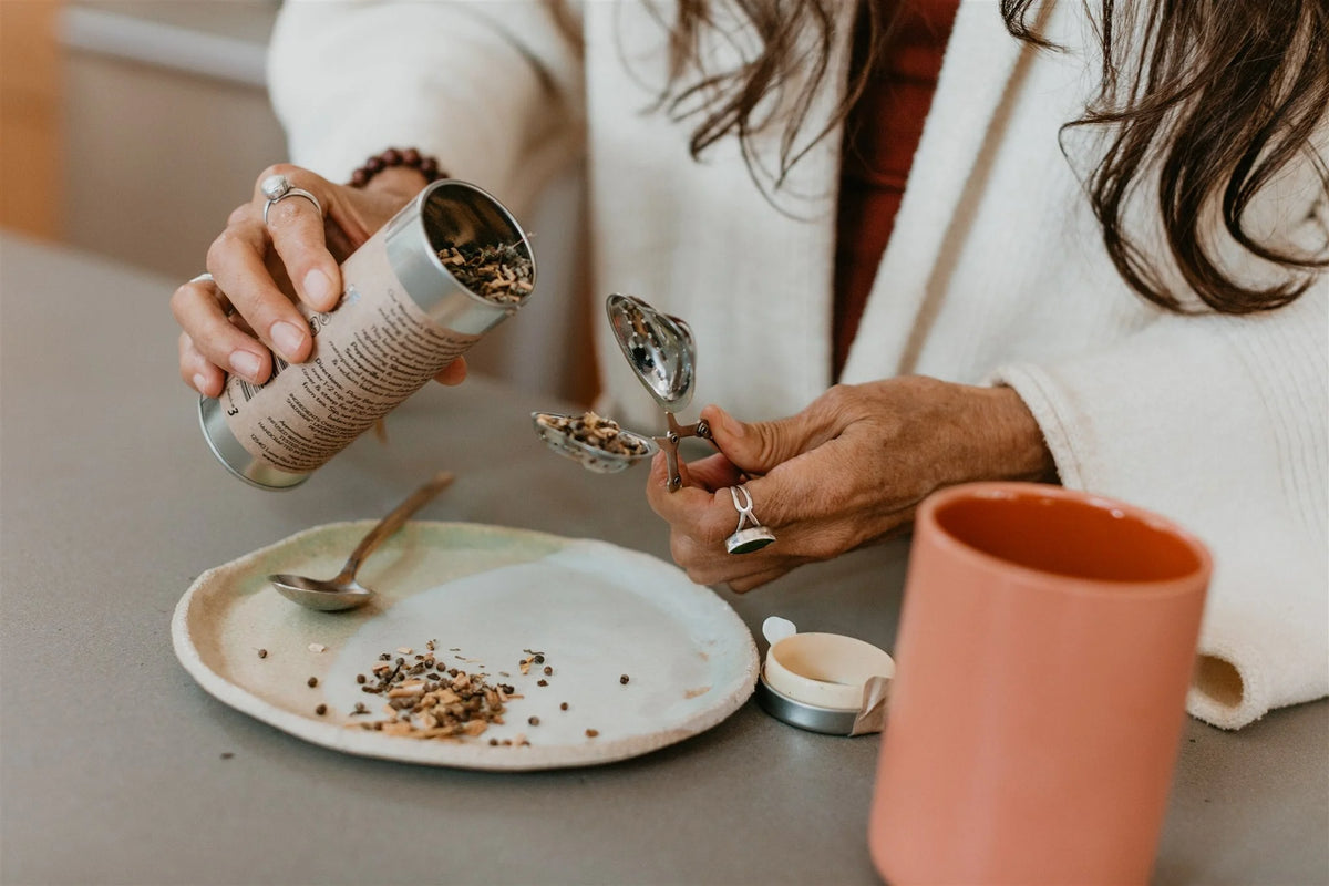 Loose-leaf herbs from Paavani Ayurveda Women’s Blend being poured