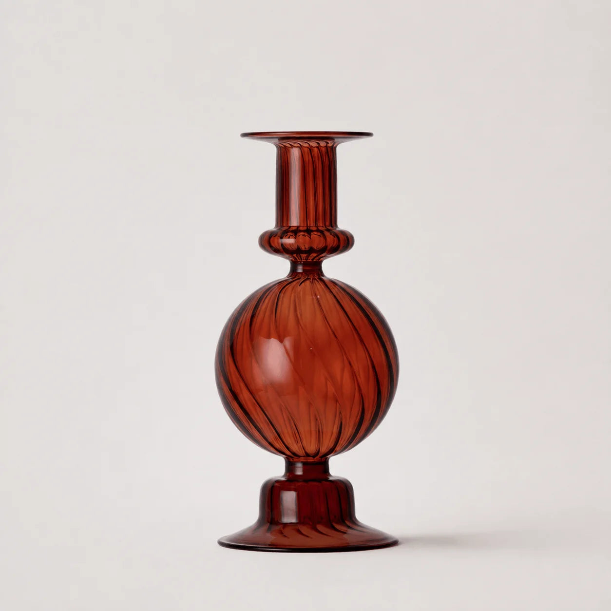 StillAura borosilicate glass candle holder, clear decorative candlestick for home decor, side angle view.