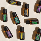 Six StillAura aromatherapy oil bottles arranged around their presentation box.