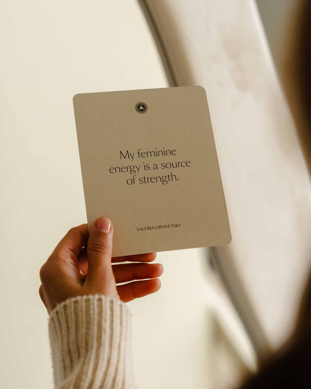 Intelligent Change Mindful Affirmations for Women card held near a window