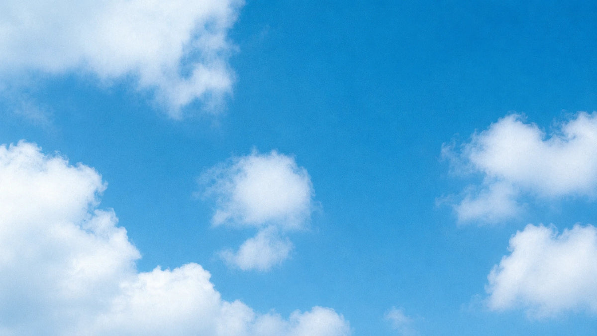 A bright blue sky with scattered white clouds.