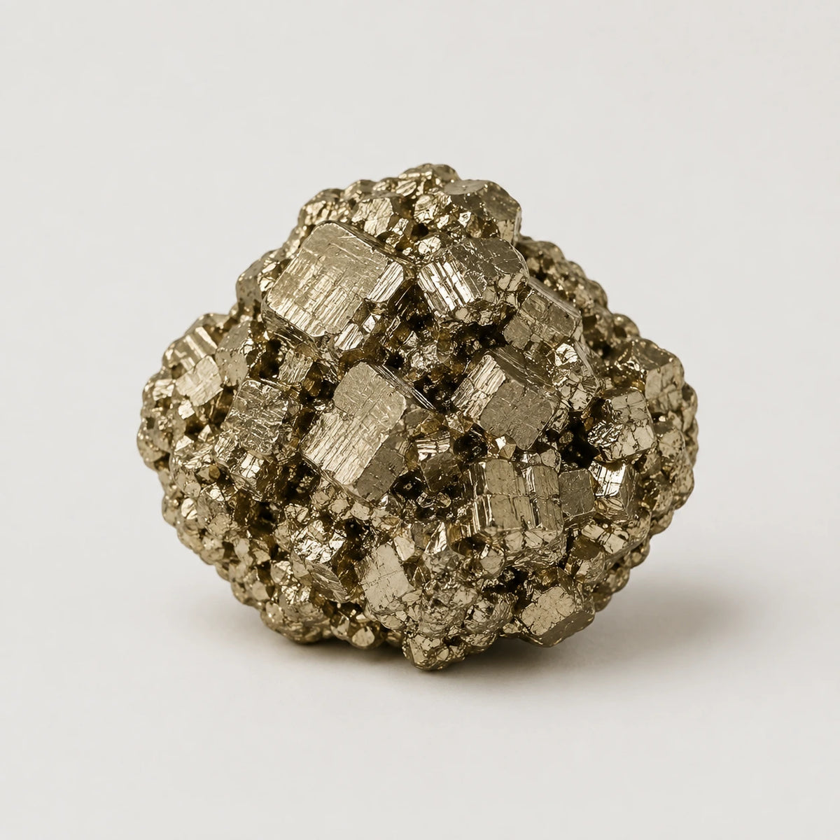 A metallic gold pyrite mineral specimen with prominent cuboid crystal structures, photographed on a clean, light gray background.