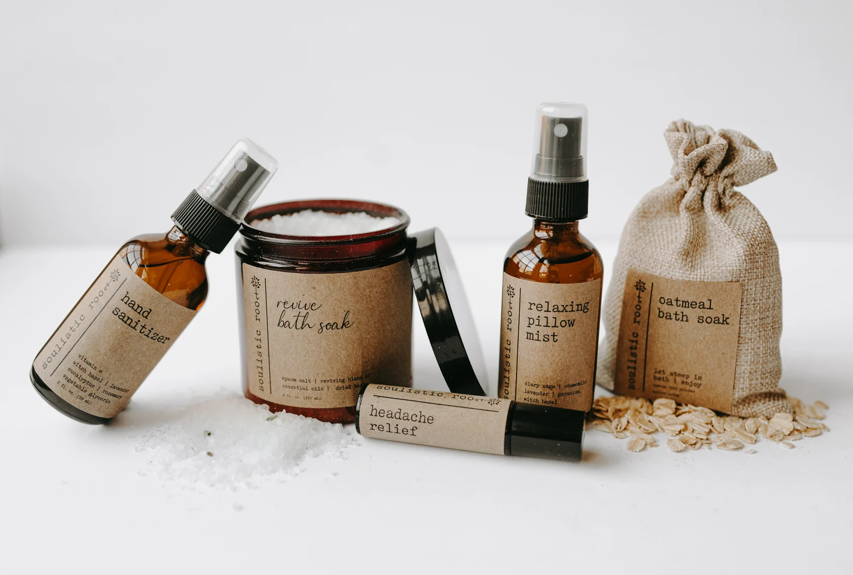 A collection of Soulistic Root wellness products including revive bath soak, relaxing pillow mist, and oatmeal bath soak for a luxury self-care experience.